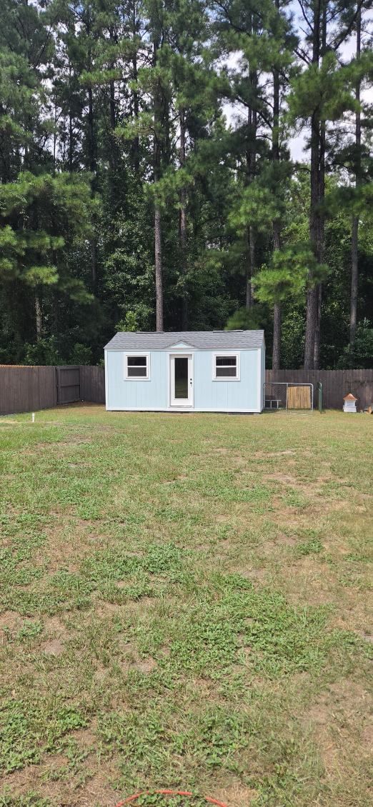 Backyard building. A finished outbuilding with windows and a glass entry door.