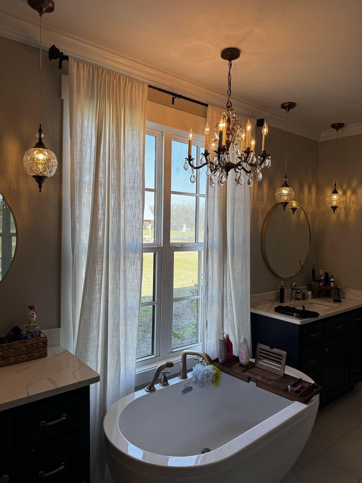 Bathroom with freestanding tub under a crystal chandelier