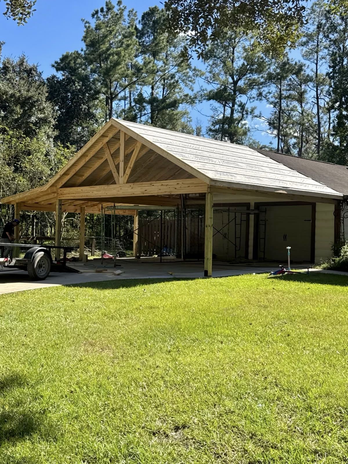 Carport addition, finished. Open-gable carport tied into the existing house.