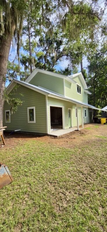Two-story home, finished. The same house with siding, trim, and roof complete.
